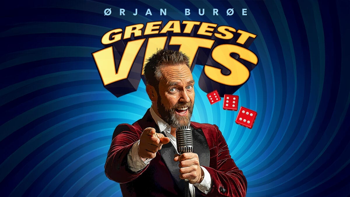 Bildet viser Ørjan Burøe med en mikrofon i hånden foran en tekst som sier "Greatest Vits"